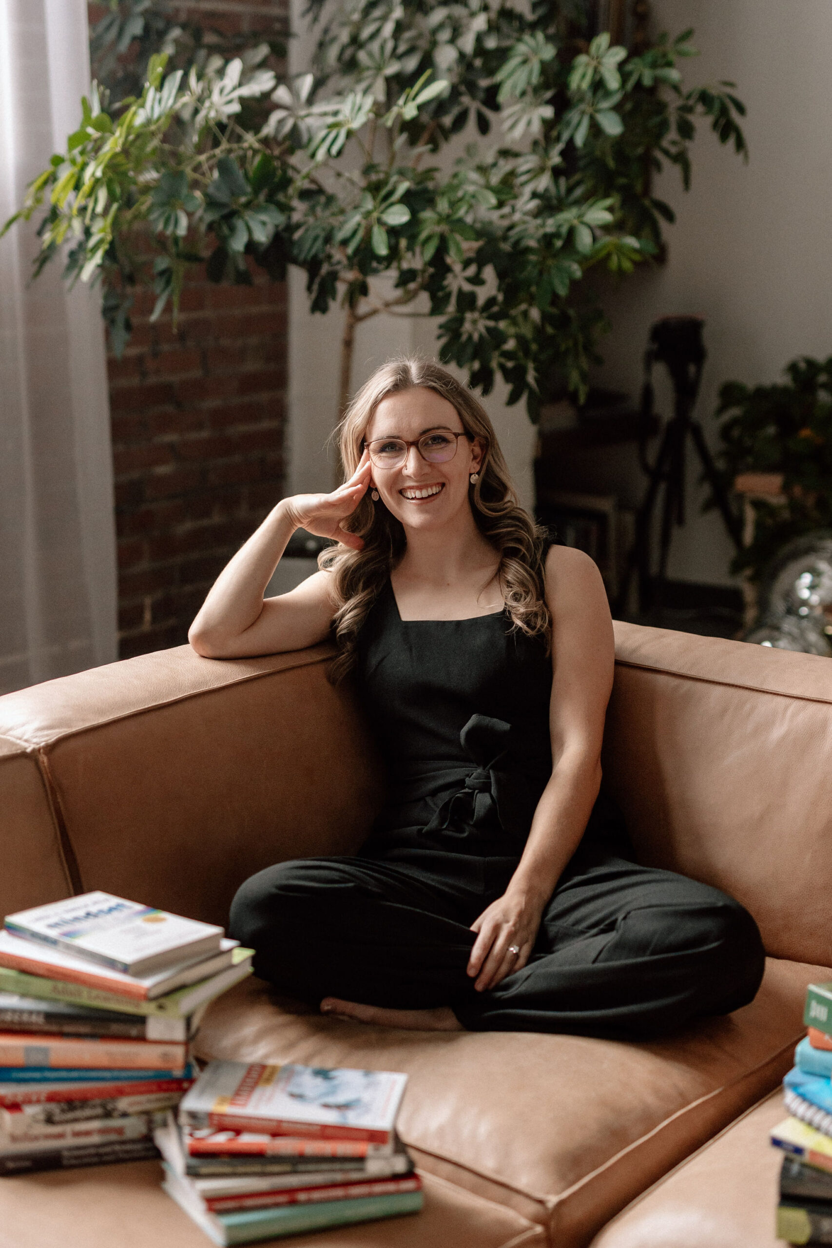 Lauren Dewey sitting on a couch, teaching why you shouldn't invest or use pre-made course content to scale your business